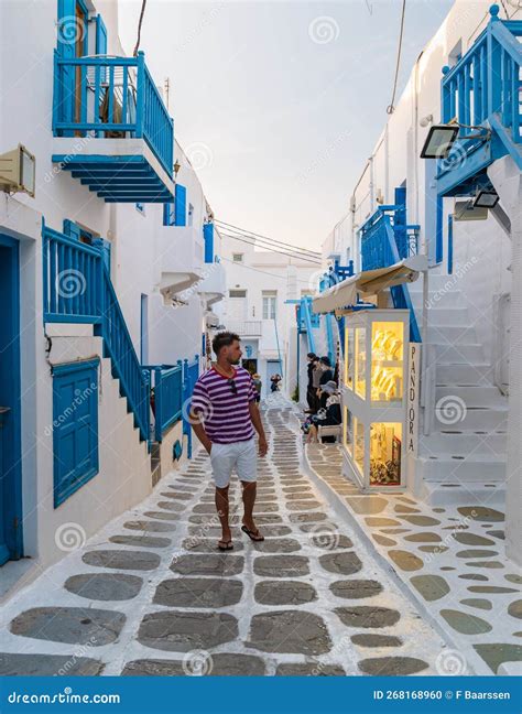 Tourist At The Streets Of Mykonos Greek Village In Greece Colorful