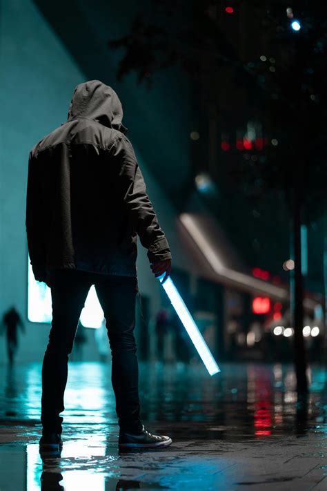 Man Wearing Black Hoodie Standing On Concrete Pavement At Night · Free