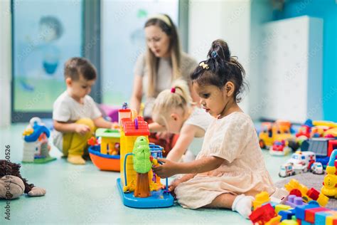 preschoolers building with toys and cubes and enjoying in kindergarten ...