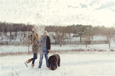 Free Photo | Young couple walking with a dog in a winter day