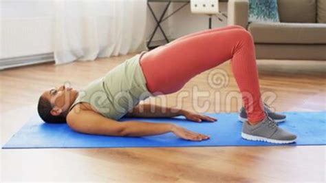 Woman Doing Pelvic Lift Abdominal Exercise At Home Stock Footage