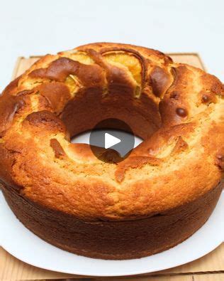 A Bundt Cake Sitting On Top Of A White Plate Next To A Wooden Cutting Board