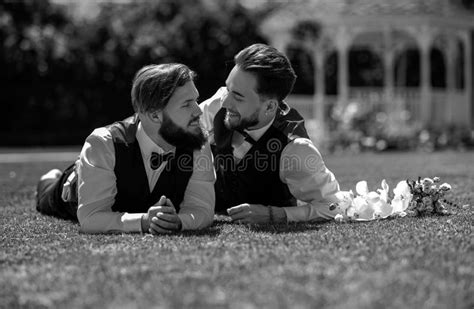 Gay Couple Laying On Grass Portrait Of Happy Gay Couple On Wedding Day Concept Of Same Sex