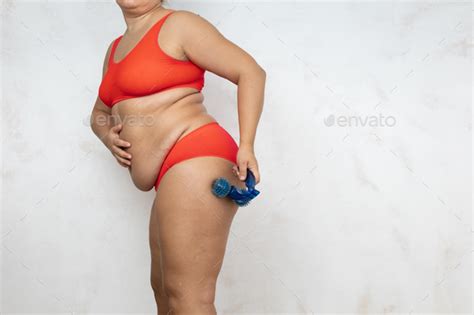 Overweight Woman Massage Hip With Blue Massager Side View White Background Naked Woman In Red