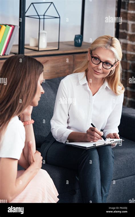 Stressed Woman Sitting On Session With Female Therapist At Office Stock