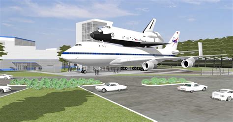 Space Center Houston hoisting shuttle replica onto top of shuttle carrier