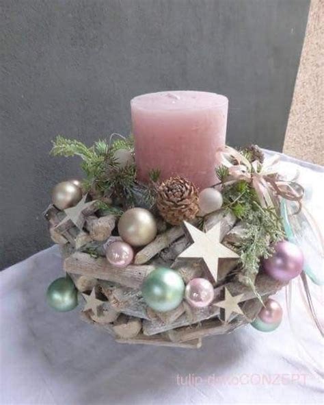 A Candle Is Sitting On Top Of Some Driftwood With Ornaments And Pineconi