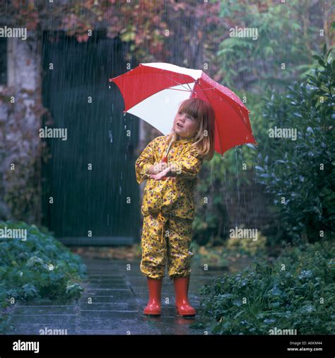 Girl with umbrella in the rain Stock Photo - Alamy