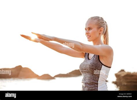 Close Up Portrait Of A Beautiful Young Woman Stretching Hands Exercises