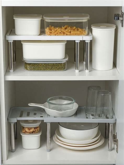 The Shelves Are Filled With Dishes And Containers For Food Items To Be