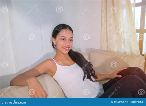 Happy Woman Sitting On The Couch The Year Old Latina Woman Enjoys