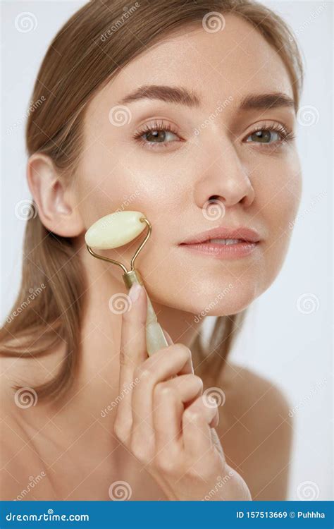 Face Massage Woman Using Jade Roller For Beauty Treatment Stock Image