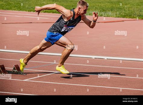 Athlete Runner Running Sprint In Starting Blocks Stock Photo Alamy