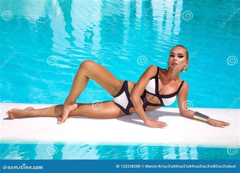 Elegant Woman In Luxury Bikini On The Sun Tanned Slim And Shapely Body