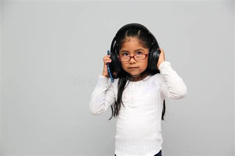 Year Old Brunette Latin Girl With Glasses Listens To Music In Her Headphones Connected To Her