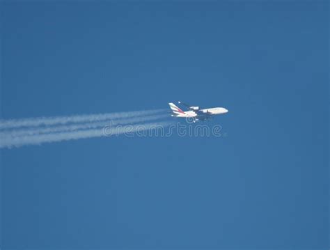 Telephoto Side View Of Passenger Jet Flying At High Altitude Editorial