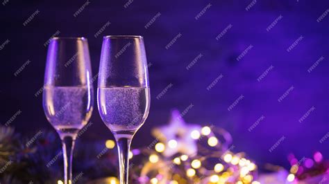 Premium Photo Two Glasses Of Champagne On A Christmas Background With