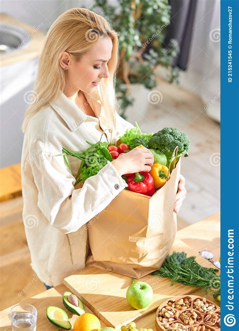 Cute Caucasian Woman Holding Shopping Paper Bag With Fruits And