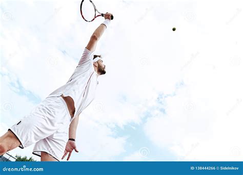 Stay Focused Tennis Player Is Looking At The Ball In The Air Stock