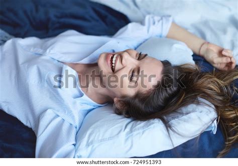 Attractive Cheerful Brunette Female Stretching Bedroom Stock Photo