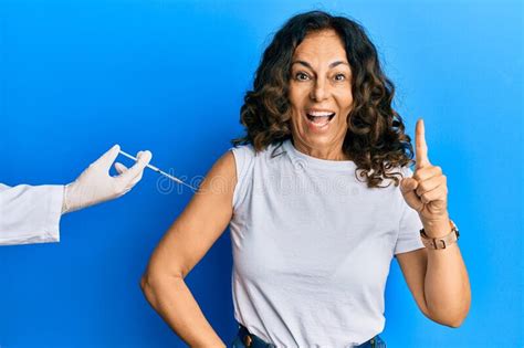 Middle Age Hispanic Woman Getting Vaccine Smiling With An Idea Or