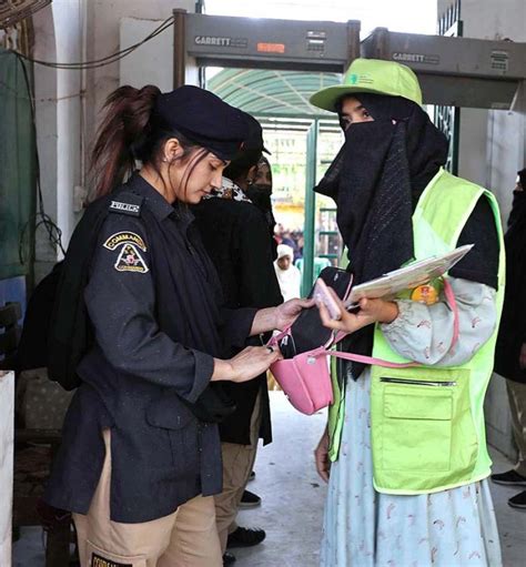 Security Official Checking The Devotees On The Entrance Point At The