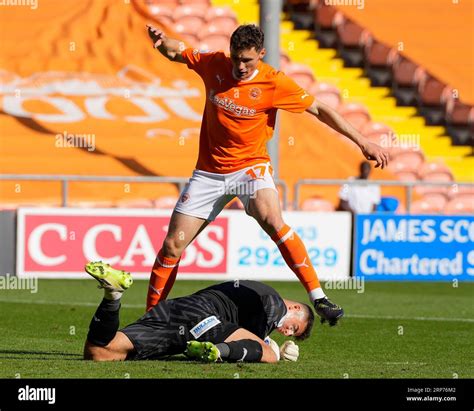 Sam Tickle Of Wigan Athletic Dives At The Feet Of Matty Virtue