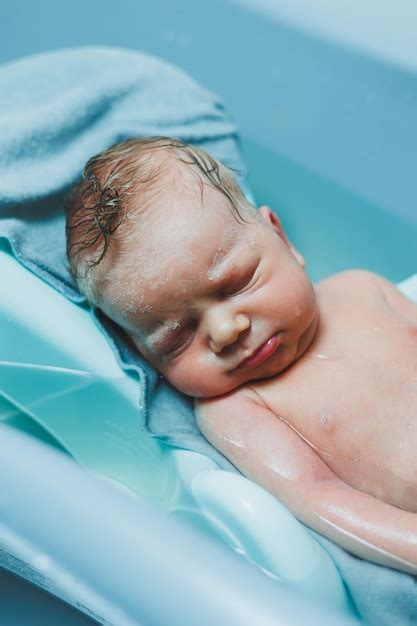 Premium Photo Bathing A Newborn Baby In A Bathtub Newborn S First