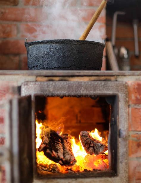 Cast Iron Cauldron Boiling A Goulash Stew Over A Wood Burning Stove