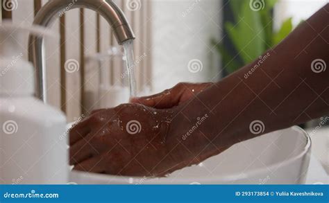 Close Up African American Man Washing Dirty Hands With Soap Warm Water