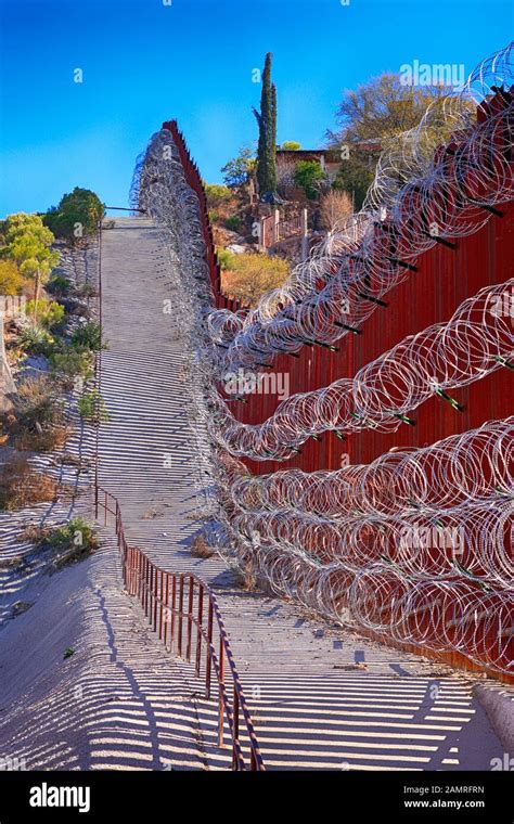 The US-Mexican border wall with layers of razor wire at Nogales AZ ...