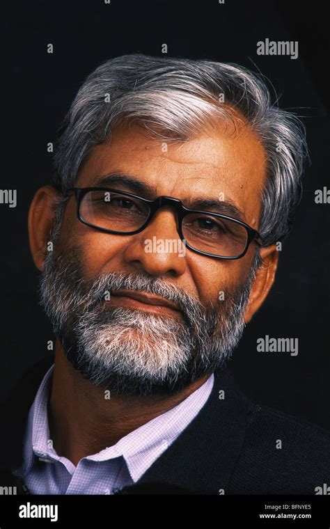 Indian Senior Man Portrait With Salt And Pepper Beard Wearing Glasses Black Background India