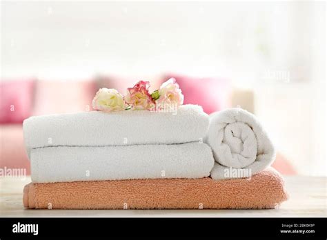 Stack Of Clean Towels On Table In Bedroom Stock Photo Alamy