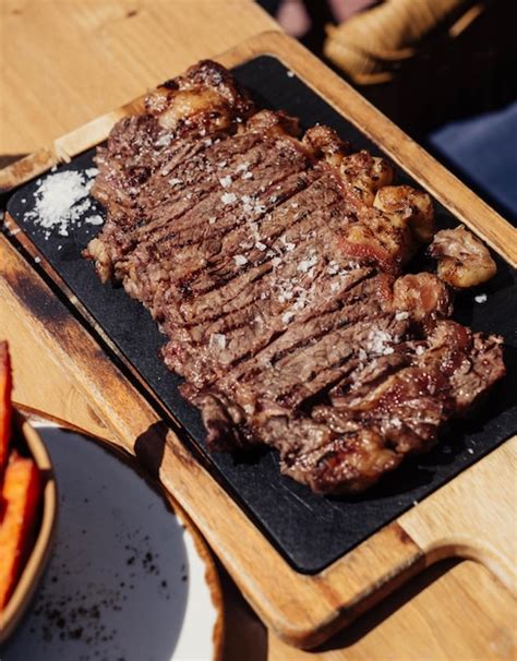 Un Bistec A La Parrilla Con Zanahorias Y Papas Fritas Foto Premium