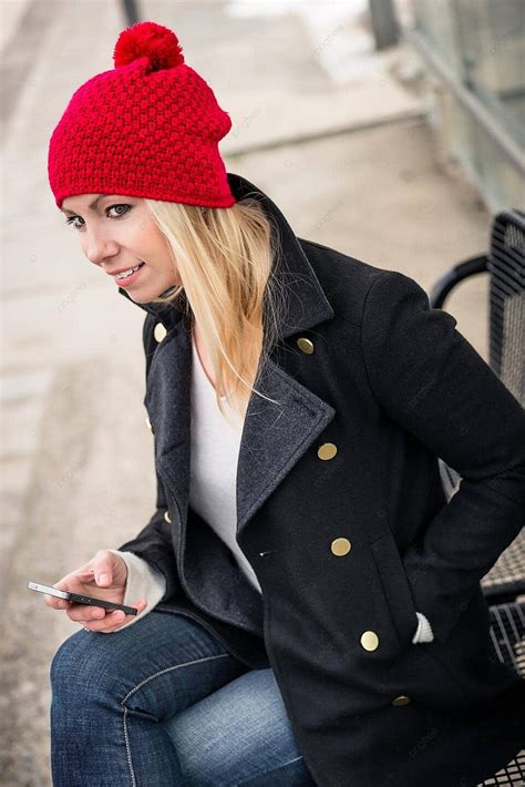 Female Commuter Engrossed In Phone While Awaiting Suburban Train Photo