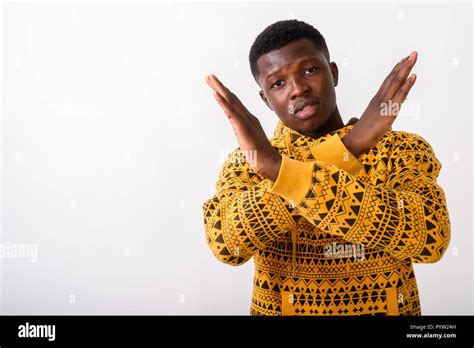 Studio shot of young black African man showing stop hand gesture Stock ...