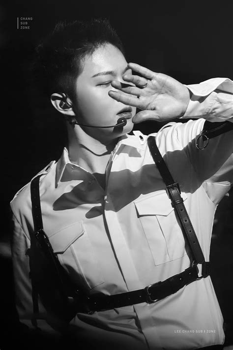 Black And White Photograph Of A Man In Uniform Saluting With His Hands