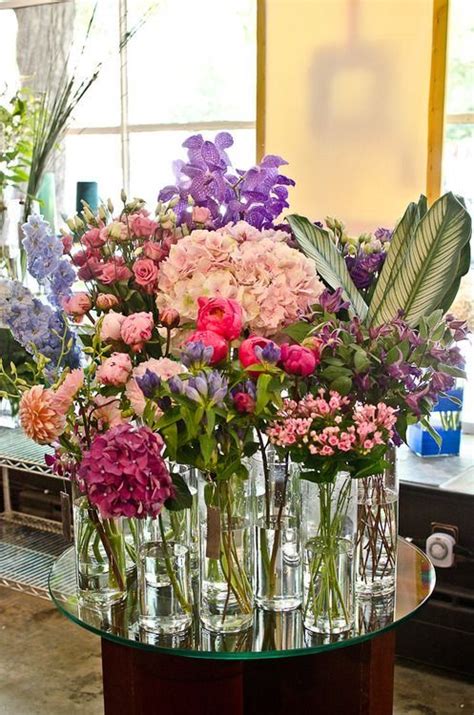 Vases Filled With Flowers Sitting On Top Of A Table