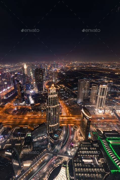 Vertical aerial view of Dubai downtown at night from the top of Burj ...