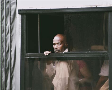 Bald Man Peeking through WindowsFree Stock Photo