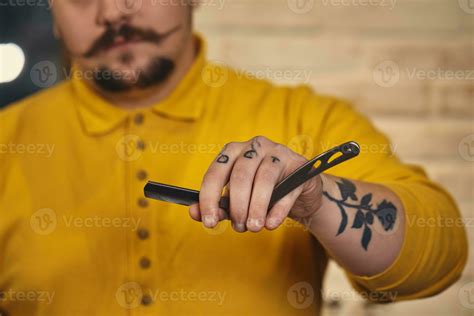 Stylish barber man with hairdressing tools in his hands prepare for ...