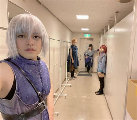 A Woman With White Hair Standing In A Hallway Next To Other Women