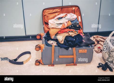 Open Suitcase Full Of Clothes In Room Stock Photo Alamy