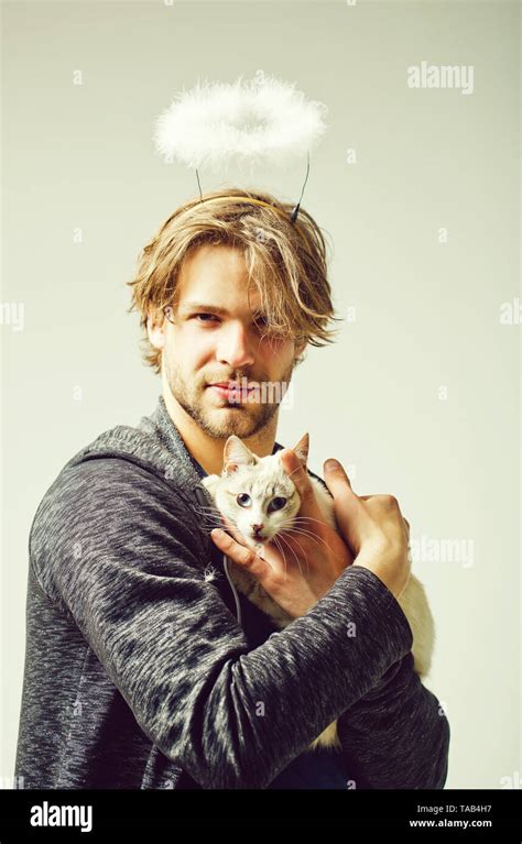 Cat And Man With Angel Halo On Head Holding Cat Stock Photo Alamy