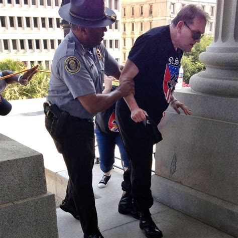 See The Moving Photo Of A Black Cop Helping A Man At Kkk Rally Time