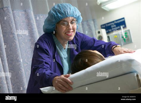 Burn Unit nurse comforts patient in bed Stock Photo - Alamy