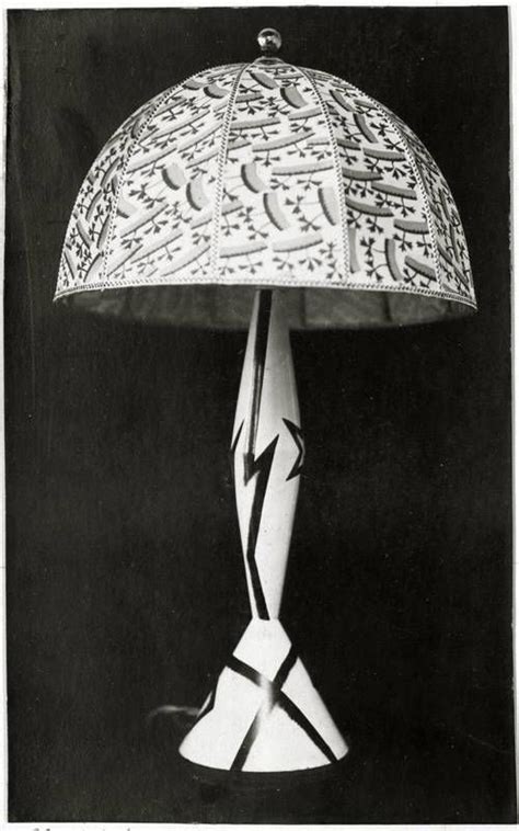 An Antique Lamp With Arabic Writing On It S Side And A White Shade Over