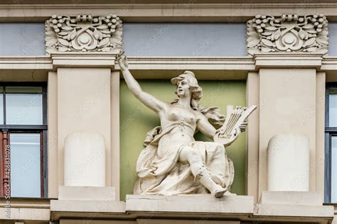 Art Nouveau sculpture at building facade. Sculpture of women playing ...