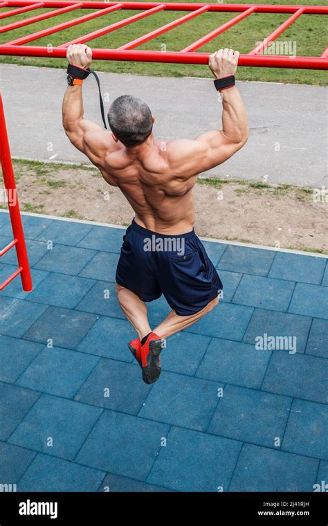 Muscular Man Doing Pull Ups On Horizontal Bar Stock Photo Alamy