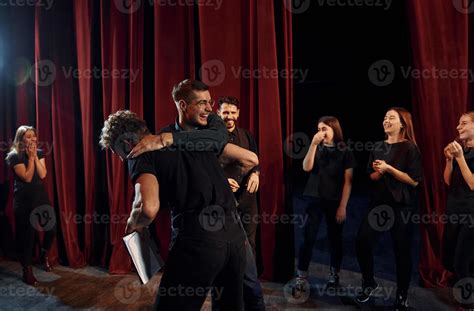 Fight scene. Group of actors in dark colored clothes on rehearsal in ...